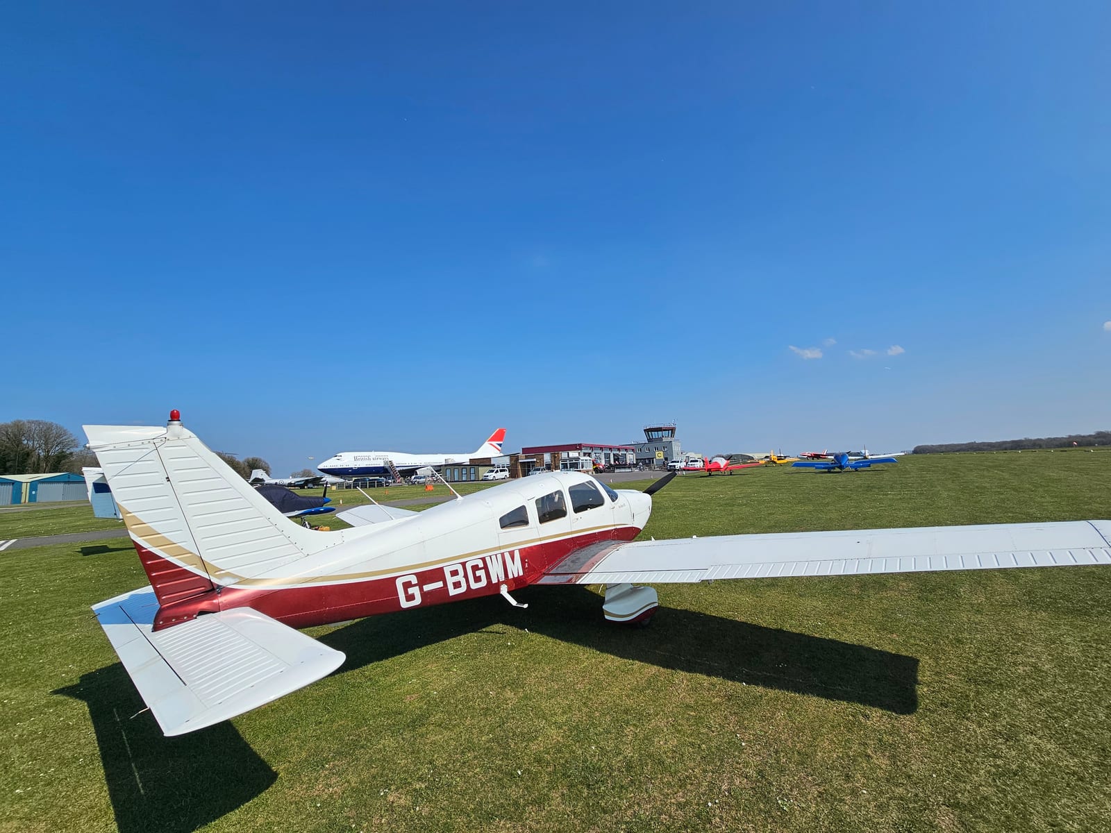 Piper PA-28 Cherokee G-BGWM parked on the grass at an airfield